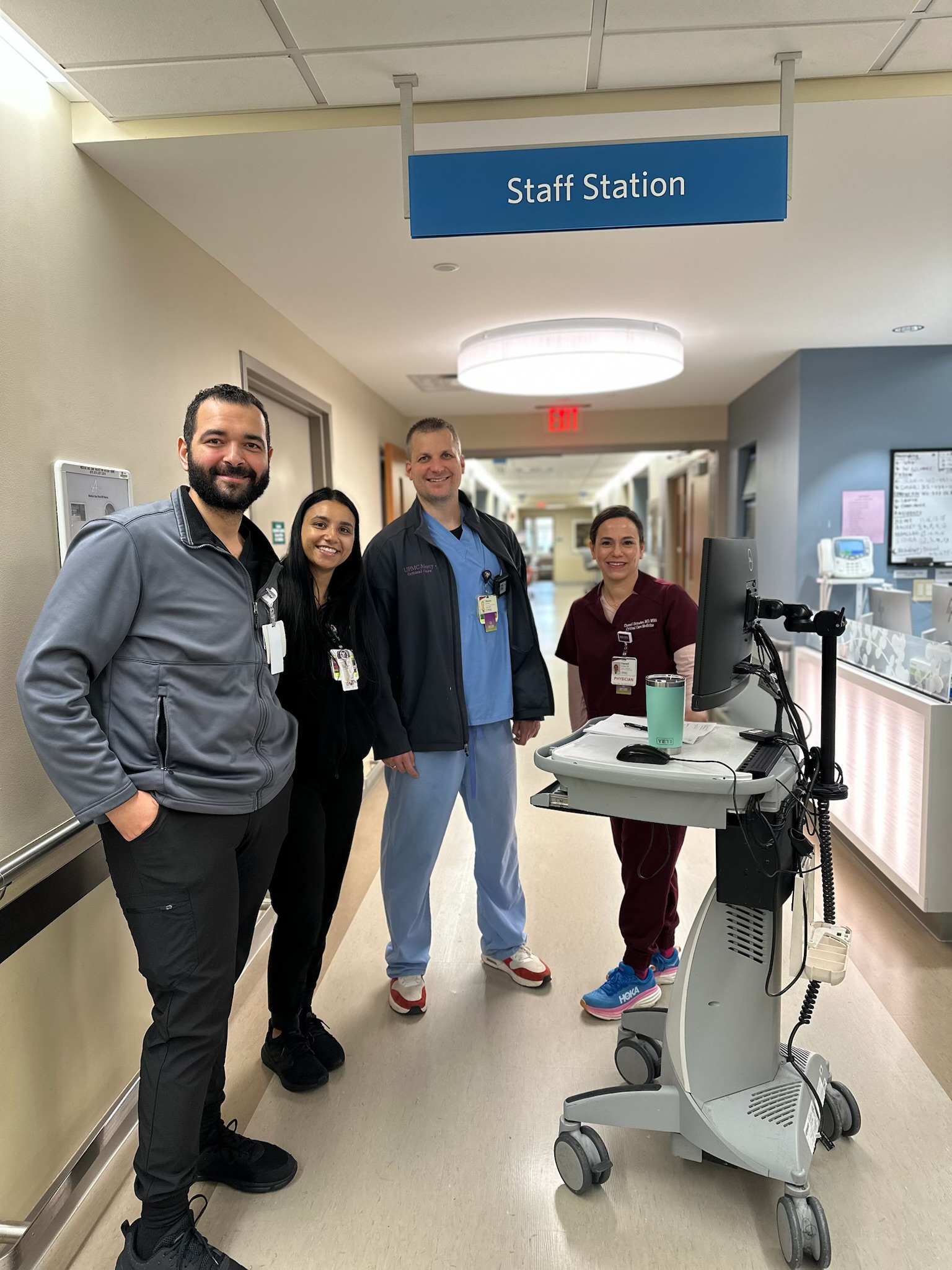 Dr. Chenell Donadee with colleagues in a hospital hallway.