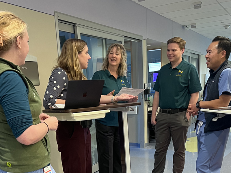 Dr. Sarah Parker meeting with her team.