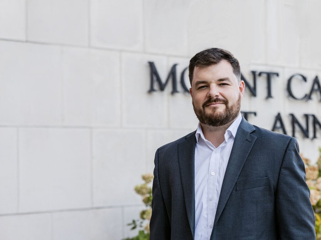Jordan DeWitt standing in front of the Mount Carmel St. Ann’s Hospital sign