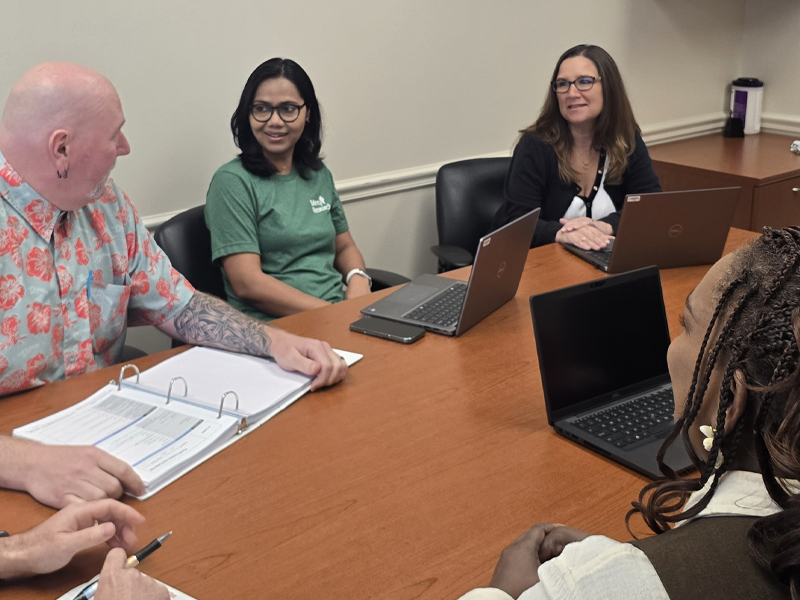 Amber Fifer in a meeting with her team.