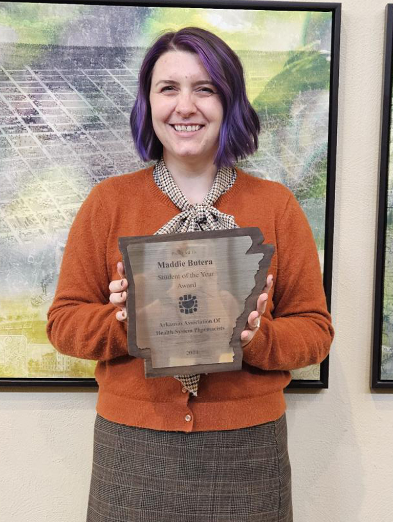 Madeline Butera holding award plaque for AAHP Student of the Year - 2024